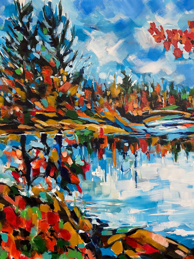 May include: A painting of a lake scene with fall foliage in shades of red, orange, yellow, and green. The trees are reflected in the water, which is a bright blue. The sky is a light blue with white clouds.