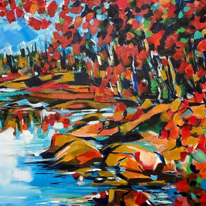 May include: Abstract painting of a landscape with a blue lake, red and orange trees, and brown rocks. The painting is done in a bold, expressive style.