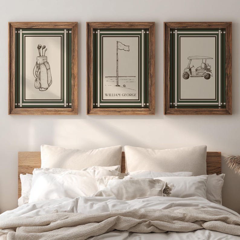 May include: Three framed golf-themed prints. Each print has a cream-colored background with a black and white illustration. The frames are a dark wood color with a green and white border. The prints depict golf clubs, a flag on the green, and a golf cart.