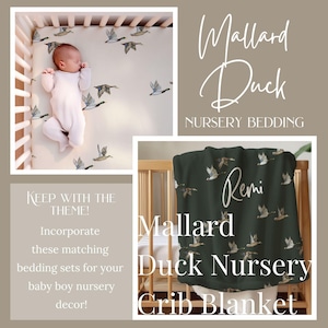 May include: A green crib blanket with a white duck print and the name "Remi" written in cursive. The blanket is part of a nursery bedding set with a mallard duck theme.