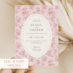 May include: A pink baby shower invitation with a floral rose pattern. The invitation features the names Olivia and Andrew, the date, time, and location. Text at the bottom reads "Edit Within Minutes".
