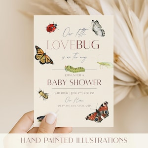 May include: A baby shower invitation with watercolor illustrations of insects, including a ladybug, butterfly, and bee. The text reads "Our little LOVEBUG is on the way" and includes event details. The words "HAND PAINTED ILLUSTRATIONS" are at the bottom.