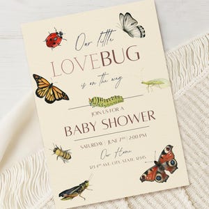 May include: Baby shower invitation with watercolor illustrations of insects and butterflies. The text reads "Our little LOVEBUG is on the way" and includes event details: date, time, and location.