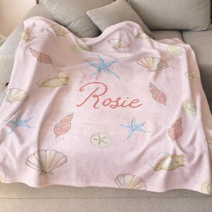 Seashell name blanket folded for gift-giving, great baby shower or hospital gift for newborn girls