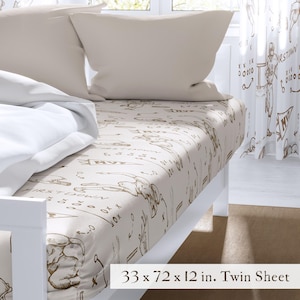 May include: A twin sheet set with a football theme. The beige sheet features brown illustrations of football plays and players. The set includes a matching pillowcase and a white bedspread. The sheet measures 33 x 72 x 12 inches.