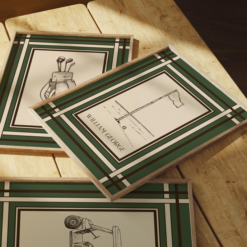 May include: Three framed golf-themed prints with green and white borders. The prints feature sketches of golf equipment and scenes, including a golf bag with clubs, a flag on the green, and a golf cart. The text "WILLIAM GEORGE" is visible on one print.
