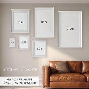 May include: A collection of white framed art prints in various sizes, including 16x20, 18x24, and 24x36 inches, displayed on a neutral wall. The text on the image indicates sizes are in inches and encourages special sizing requests.