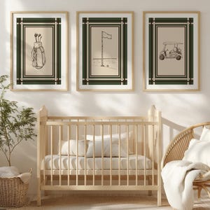 May include: Three framed golf-themed prints. The prints feature a golf bag with clubs, a flag on the green, and a golf cart. Each print has a beige background with a dark green and black border, and a light wood frame.