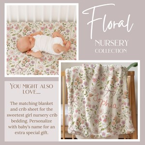 May include: Floral nursery collection featuring a crib sheet and blanket with a floral pattern in pink, peach, and lavender. The blanket is draped over a crib and has the name "Sophia" embroidered on it. The crib sheet has a matching floral design.