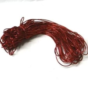 May include: A collection of shiny, reddish-brown craft wire, secured at one end. The thin, flexible wire is suitable for various craft projects. The bundle is presented against a white backdrop.