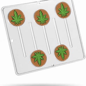 May include: A clear plastic candy mold featuring five circular cavities, each designed to create a round lollipop with a detailed green cannabis leaf imprint centered on a brown background, complete with integrated channels for lollipop sticks.