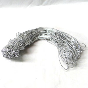 May include: A bundle of silver elastic cord, perfect for jewelry making or crafts.