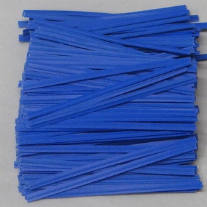 May include: A large pile of blue twist ties. The ties are made of a thin, flexible material and are used to secure items together.