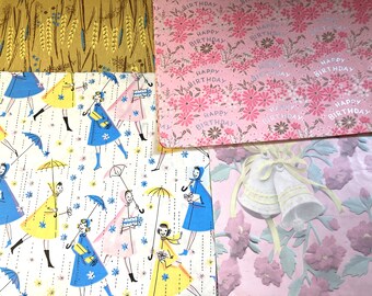 May include: Selection of vintage wrapping paper sheets. Designs include a wheat pattern, a pink floral "Happy Birthday" print, a pattern of women with umbrellas, and a pink floral design with embossed bells.
