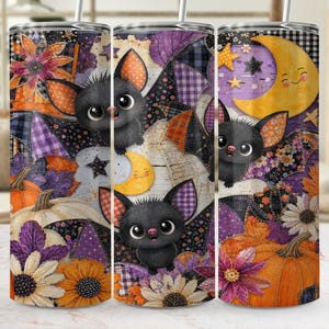 May include: A cylindrical tumbler featuring a repeating pattern of cartoon bats with large eyes, orange and purple plaid fabric textures, yellow crescent moons, orange pumpkins, and various flowers in shades of orange, purple, and white.