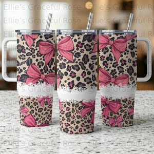 May include: Three stainless steel tumblers with lids and straws. The tumblers feature a leopard print design with pink bows and a white band. The text "Ellie's Graceful Rose" is visible on the tumblers.