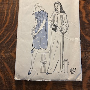 May include: A vintage Butterick sewing pattern envelope 4415, size 42, featuring illustrations of two dress styles. Style B is a short-sleeved floral dress, and Style A is a long-sleeved floor-length dress. The text includes Butterick, 4415, and Quick and Easy.