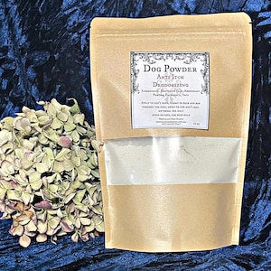 May include: A brown paper bag with a white label that reads "Dog Powder Anti Itch Deodorizing". The label lists ingredients including Bentonite Clay, Arrowroot Powder, Calendula, Oats. The label also includes instructions for use and a warning to avoid use on cats. The bag contains a white powder.