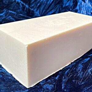 May include: A large, rectangular bar of white soap. The soap is smooth and appears to be unscented.
