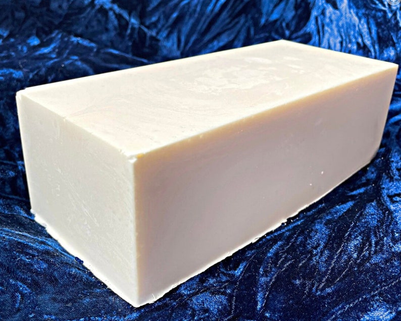 May include: A large, rectangular bar of white soap. The soap is smooth and appears to be unscented.