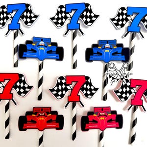 May include: A collection of racing-themed cake toppers. The toppers feature a blue or red race car, a number 7, and a checkered flag. The number 7 and flag are on a stick with black and white stripes. The race cars have the number 98 on them.