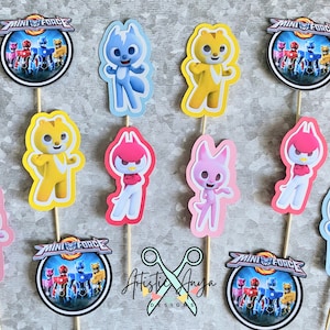 May include: A set of 10 cupcake toppers featuring characters from the cartoon show Mini Force. The toppers include the Mini Force logo, a blue, yellow, and pink cat character, and a red bird character.