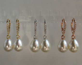 May include: Three pairs of pearl drop earrings with crystal accents. The earrings are available in gold, silver, and rose gold.