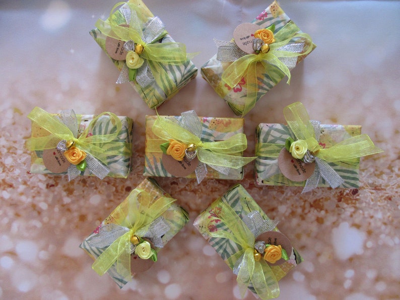 May include: Six small gift boxes wrapped in yellow and green patterned paper with yellow ribbon and a small flower embellishment. Each box has a small brown tag with the text "Thank you for being you".