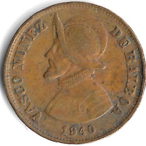 May include: A bronze coin featuring a profile of a man in a helmet, with the inscription "VASCO NUNEZ DE BALBOA" and the date "1940". The coin has a circular shape and a worn appearance.