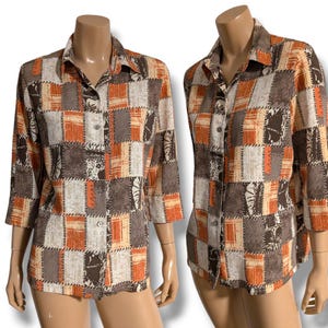 May include: A long-sleeved button-down shirt with a patchwork design in shades of brown, orange, and white.