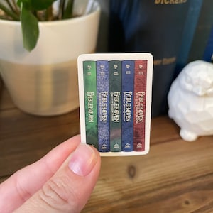 May include: A set of five paperback books with blue, green, and red covers. The books are titled "Fablehaven" and each book has a different subtitle. The books are arranged in order from left to right, with the first book being "Fablehaven: Keys to Demon Prison" and the last book being "Fablehaven:  Tufts Evening Star."