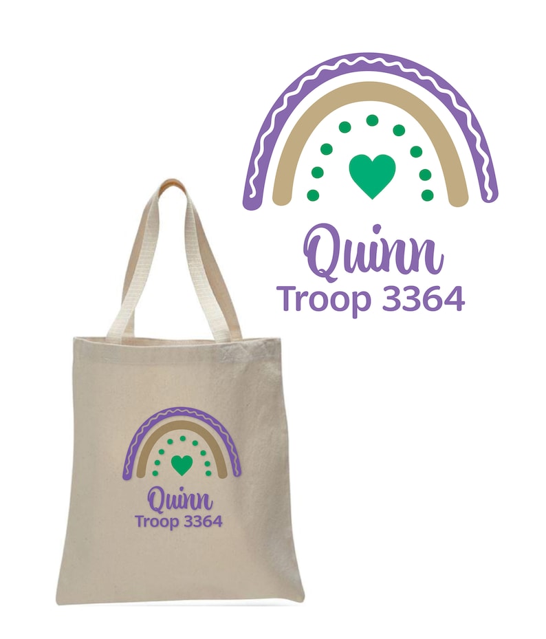 May include: A beige canvas tote bag with a purple and brown rainbow design, a green heart, and the text "Quinn Troop 3364".