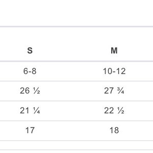 May include: Size chart for a garment with measurements in inches for XS, S, M, L, and XL sizes. The chart shows sleeve length, full body length, and body width.