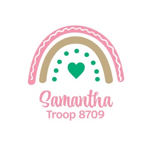 May include: A pink and brown rainbow with a green heart in the center. The text "Samantha Troop 8709" is below the rainbow.