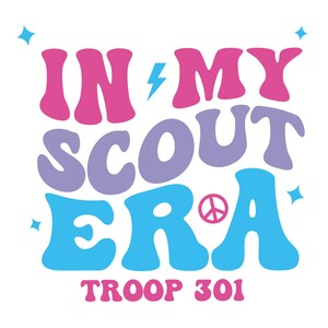 May include: A retro-style graphic with the text "IN MY SCOUT ERA" in pink, purple, and blue lettering. A peace sign is incorporated into the "R" of "ERA". The text "TROOP 301" is below the main text.