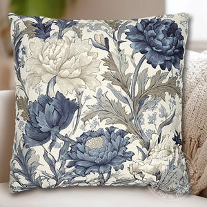 May include: Square throw pillow with a floral pattern featuring large blue and beige peonies and foliage on a cream background. The pillow has a classic, elegant design, suitable for home decor.