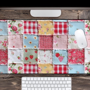 May include: A rectangular mousepad with a patchwork design. The patchwork features squares of fabric in various patterns, including floral, gingham, and strawberry prints. The color palette includes red, pink, blue, and yellow. A white mouse and keyboard are also visible.