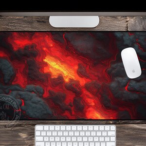 May include: A rectangular mouse pad with a fiery red and orange lava design, accented with dark gray and black areas. A white computer mouse rests on the pad, with a white keyboard below. The Old Country Porch logo is in the lower left corner.