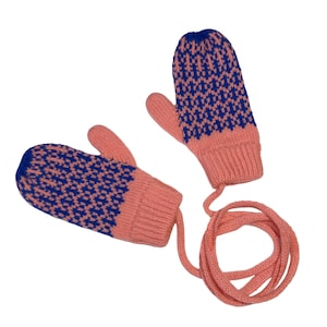 May include: A pair of knitted mittens in coral pink and blue. The mittens have a blue geometric pattern on the top and a coral pink cuff and palm. A coral pink cord connects the two mittens. The mittens are designed for warmth and style.
