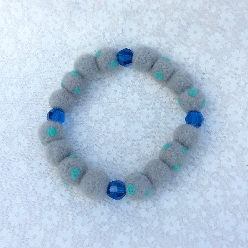 Handmade felt ball bracelet. Grey felt balls with turquoise dot Handmade felt ball bracelet. Grey felt balls with turquoise dot