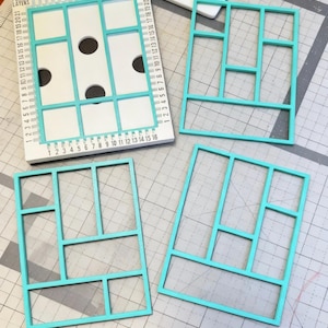 May include: A white rectangular alignment tool labeled PERFECT LAYERS with numbered edges from 1 to 21 and three circular cutouts, accompanied by three teal rectangular frames with internal dividers, all resting on a gray grid cutting mat.