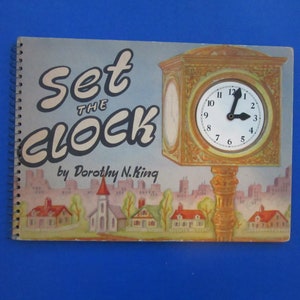 May include: A vintage children's book titled "Set the Clock" by Dorothy N. King. The cover features a colorful illustration of a clock tower with a clock face set to 12:00. The background shows a small town with houses and a church.