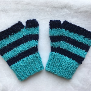 May include: A pair of fingerless gloves with blue and dark blue stripes. The gloves are knitted and have a textured look.