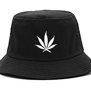 May include: Black bucket hat with a white marijuana leaf design.
