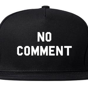 May include: A black baseball cap with a white embroidered design that says "NO COMMENT".