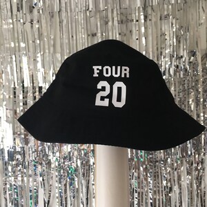 May include: Black bucket hat with white text that says "FOUR 20" on the front.