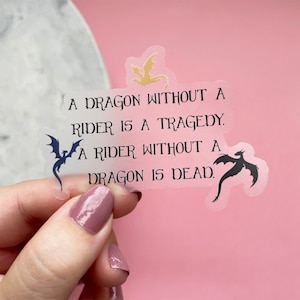 May include: A clear sticker with a quote about dragons and riders. The quote reads: "A dragon without a rider is a tragedy. A rider without a dragon is dead."