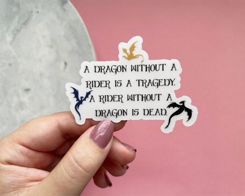 May include: A white sticker with black text and three black dragon silhouettes. The text reads: "A dragon without a rider is a tragedy. A rider without a dragon is dead."