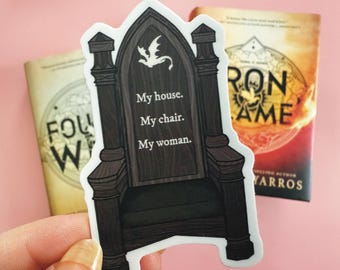 May include: A white sticker with a black and brown illustration of a throne. The throne has a dragon on the back and the words "My house. My chair. My woman." on the front.