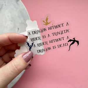 May include: A clear sticker with a black and white dragon silhouette and the text "A dragon without a rider is a tragedy. A rider without a dragon is dead."